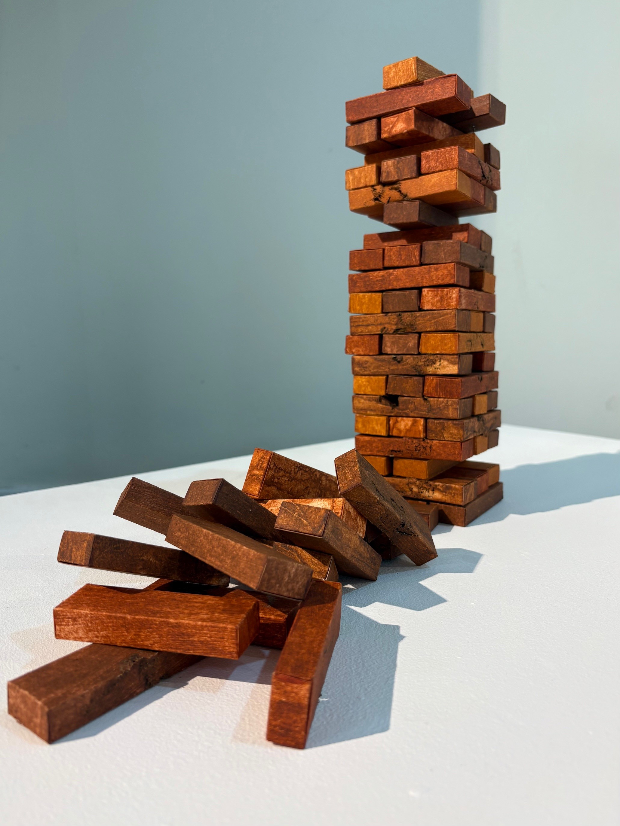 Image of Carolyn Murphy's work In the Balance, which is made of hand printed paper, suggesting Jenga bricks, precariously stacked.